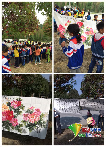 谢航宇先生在石板小学举办了书画展。图为学生在欣赏谢航宇先生的书画作品。唐婉贞供图
